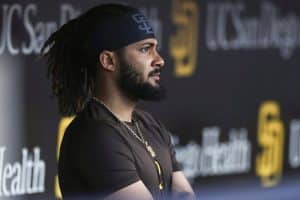 Media by Associated Press - FILE - San Diego Padres' Fernando Tatis Jr. looks out from the dugout prior to the team's baseball game against the Philadelphia Phillies on June 25, 2022, in San Diego. Tatis was suspended 80 games by Major League Baseball on Friday, Aug. 12, after testing positive for a performance-enhancing substance. The penalty was effective immediately, meaning the All-Star shortstop cannot play in the majors this year. Tatis had been on the injured list all season after breaking his left wrist in spring training. (AP Photo/Derrick Tuskan, File)
