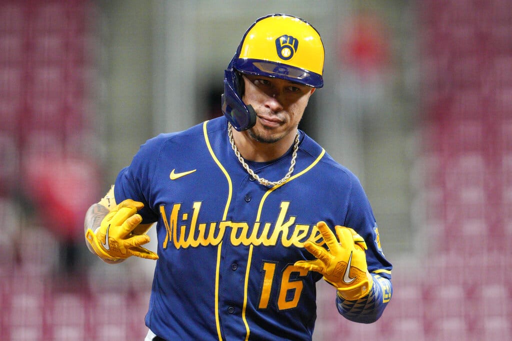 Media by Associated Press - Milwaukee Brewers' Kolten Wong gestures as he runs the bases after hitting his third home run of the night, during the eighth inning of the team's baseball game against the Cincinnati Reds on Thursday, Sept. 22, 2022, in Cincinnati. (AP Photo/Jeff Dean)